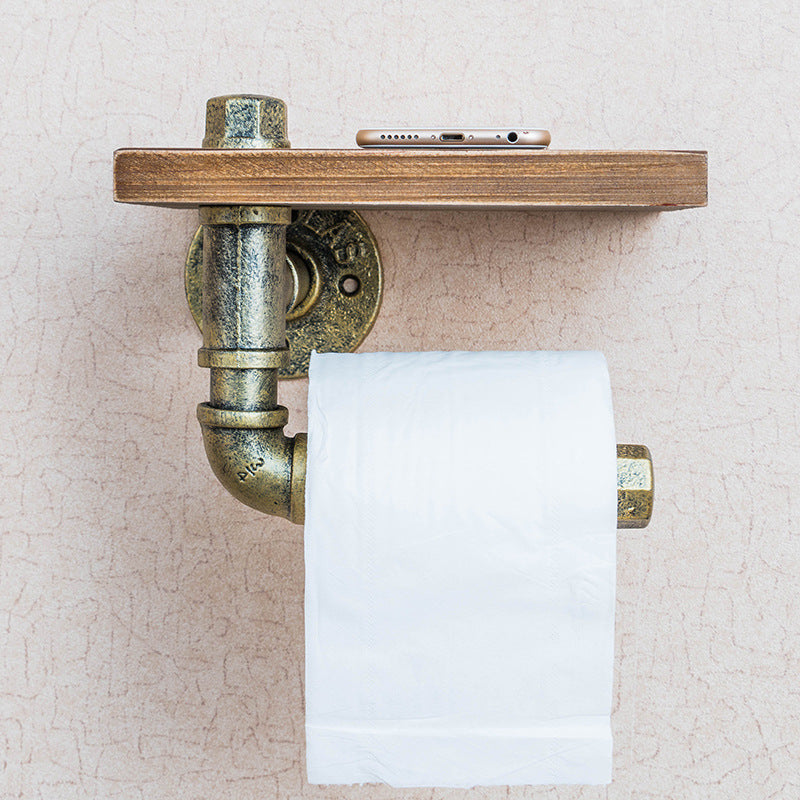 A functional and stylish toilet paper holder featuring industrial pipe design, rustic wooden shelf, and cast iron pipe hardware, perfect for adding a touch of industrial charm to your bathroom decor.