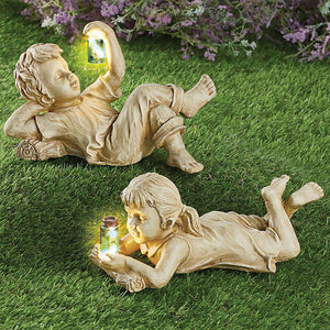 A charming garden statue crafted from resin, depicting a boy and girl with a firefly jar, adding whimsy and delight to your outdoor space.