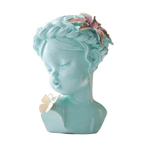 A delicate figurine depicting an angel gently kissing a butterfly, capturing a moment of serenity and beauty.