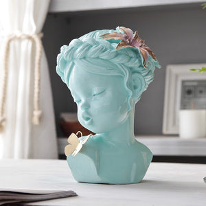 A delicate figurine depicting an angel gently kissing a butterfly, capturing a moment of serenity and beauty.