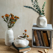 A unique vase with an asymmetric design, crafted from bisque ceramic, showcasing modern elegance and artistic flair.