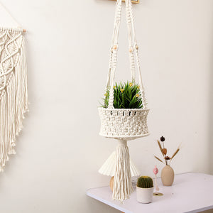 A stylish macrame plant hanger designed to hold flower pots, serving as both a functional planter and decorative wall accent.