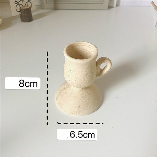 Ceramic Hand-held Candle Holder Decoration: A beautifully crafted ceramic candle holder designed to be held by hand, adding a touch of warmth and style to any space.