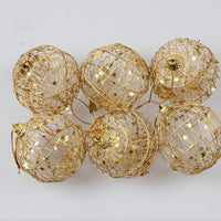 A festive Christmas ball ornament with a scaly texture and golden dusting, adding a touch of glamour and sparkle to holiday decorations.