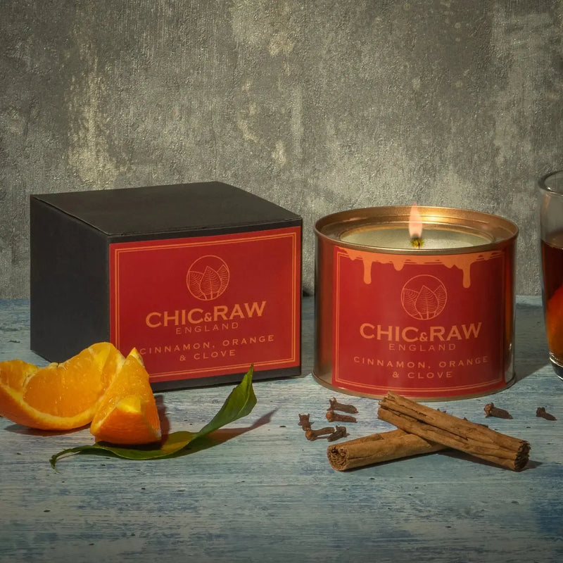 Lit cinnamon and orange clove candle, festive aroma, organic candle