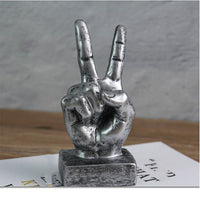 A stylish resin figurine featuring a hand gesture design, adding a modern and artistic flair to your home decor.