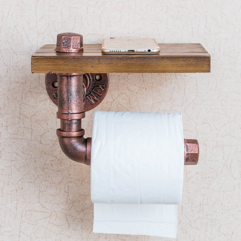 A functional and stylish toilet paper holder featuring industrial pipe design, rustic wooden shelf, and cast iron pipe hardware, perfect for adding a touch of industrial charm to your bathroom decor.