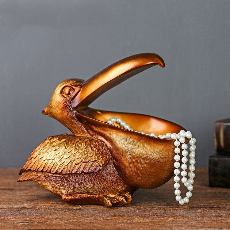 A decorative toucan statue designed as a jewelry and key organizer, adding a tropical and functional touch to your home decor.