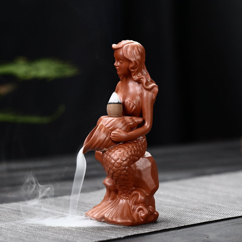 Creative Conch Mermaid Incense Burner: An imaginative incense burner shaped like a conch shell with a mermaid design, adding a whimsical touch to your space while infusing it with delightful fragrances.