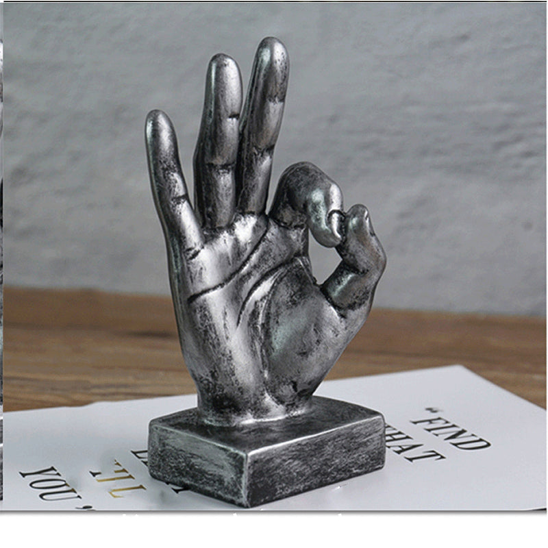 A stylish resin figurine featuring a hand gesture design, adding a modern and artistic flair to your home decor.