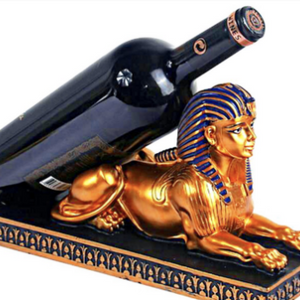 A regal wine bottle holder in the shape of an Egyptian Pharaoh Sphinx, adding an exotic and majestic touch to your home decor.