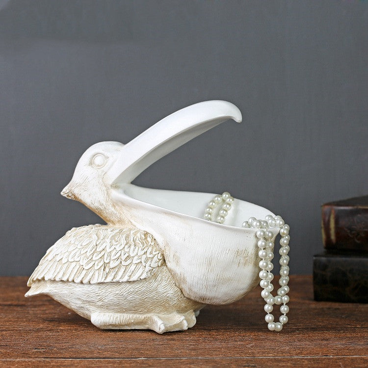 A decorative toucan statue designed as a jewelry and key organizer, adding a tropical and functional touch to your home decor.