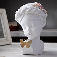 A delicate figurine depicting an angel gently kissing a butterfly, capturing a moment of serenity and beauty.