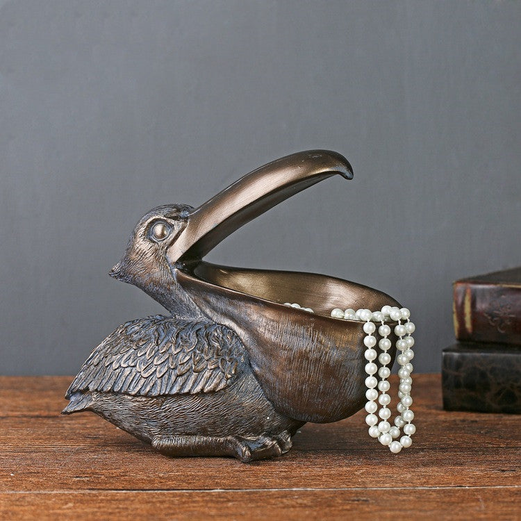 A decorative toucan statue designed as a jewelry and key organizer, adding a tropical and functional touch to your home decor.