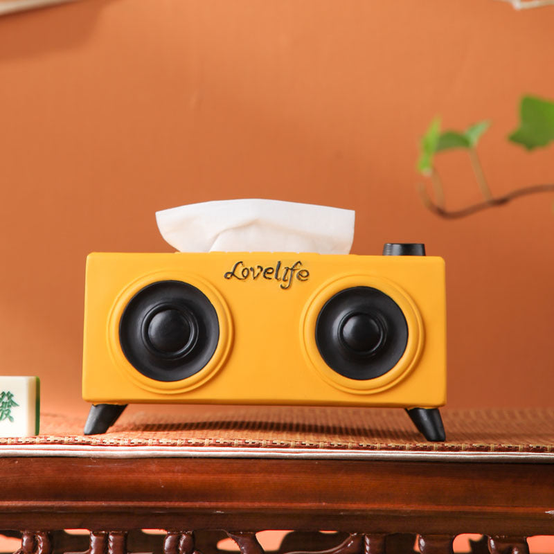 A unique tissue holder inspired by retro speakers, serving as a quirky and nostalgic coffee table decoration