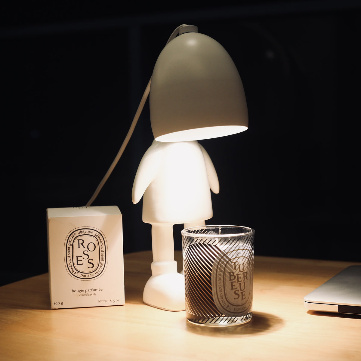 A whimsical night light in the shape of a robot, doubling as a scented melting candle lamp for a charming and fragrant ambiance.