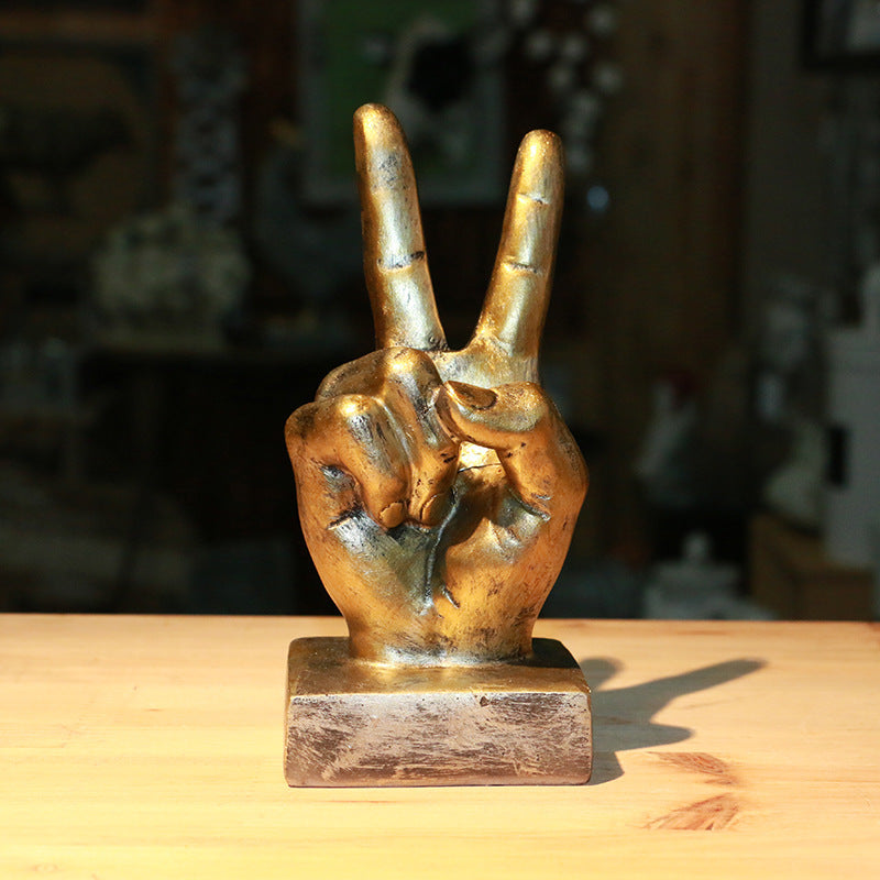 A stylish resin figurine featuring a hand gesture design, adding a modern and artistic flair to your home decor.